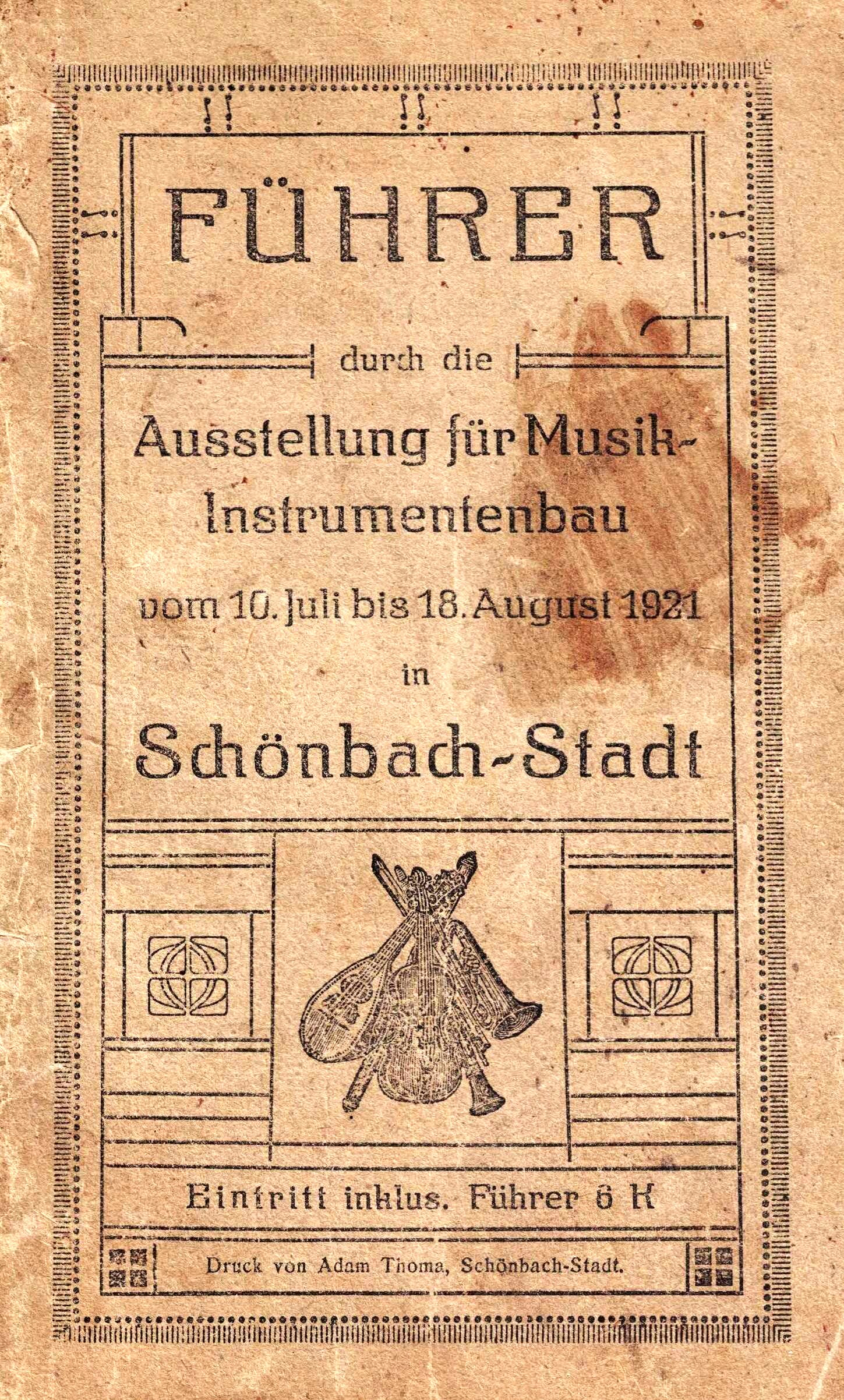 1921年「FÜHRER durch die Ausstellung für Musik-Instrumentenbau」展覧会案内の古びた茶色の表紙。Schönbach-Stadt（1921年7月10日–8月18日）、楽器の小さな版画、案内付き入場5クローネ。